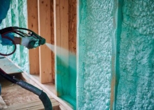 insulation being sprayed into the walls of a home